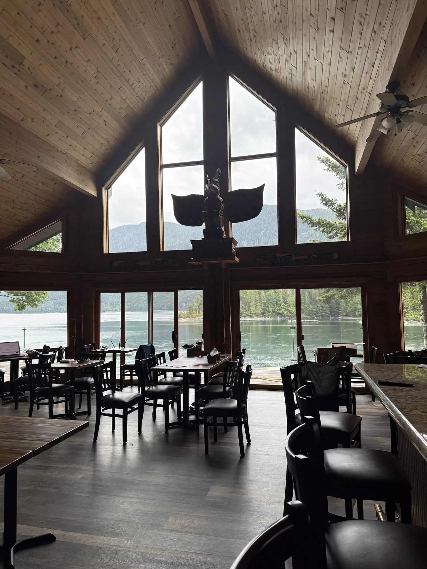 The restaurant dining room with vaulted cedar ceiling and views over the water